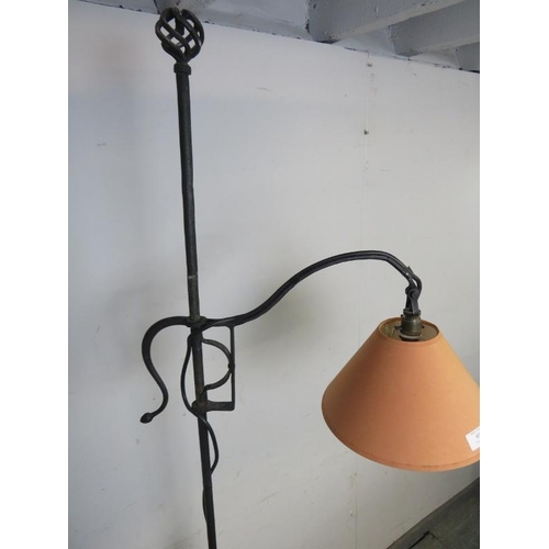 855 - A large vintage wrought iron reading lamp in the Gothic taste, on splayed supports. 
H193cm W46cm D3... 