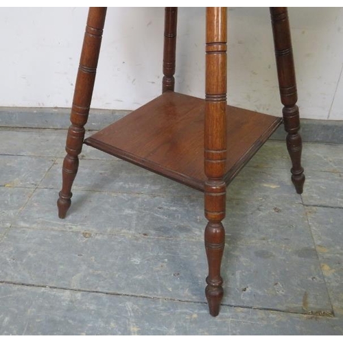 857 - A turn of the century mahogany two tier occasional table, on canted turned supports. 
H64cm W45cm D4... 