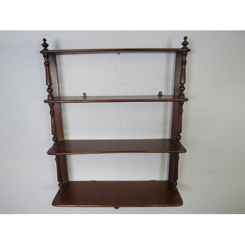 865 - A Victorian mahogany ‘waterfall’ wall hanging shelf of four graduated open shelves, having turned fi... 