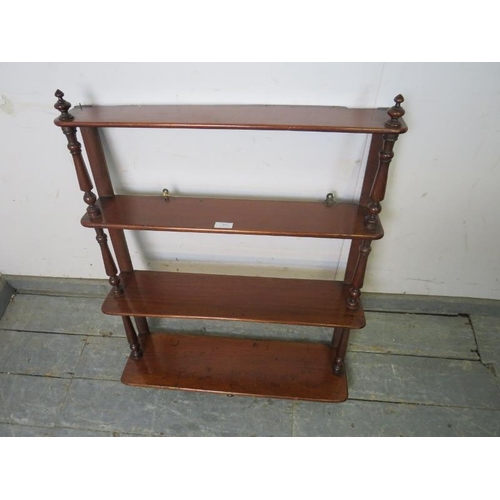 865 - A Victorian mahogany ‘waterfall’ wall hanging shelf of four graduated open shelves, having turned fi... 