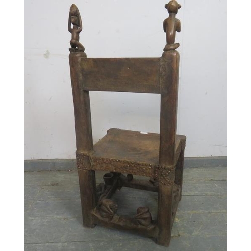 879 - A vintage African hardwood Chokwe tribal chief’s throne chair, the rawhide seat with metal studs, ha... 