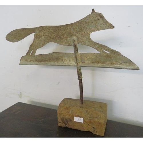 883 - An antique weathervane, modelled as a running fox, mounted on an oak base. 
H45cm W58cm D11cm (appro... 