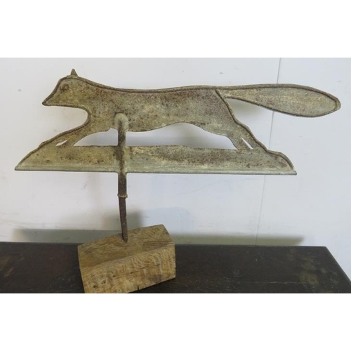 883 - An antique weathervane, modelled as a running fox, mounted on an oak base. 
H45cm W58cm D11cm (appro... 