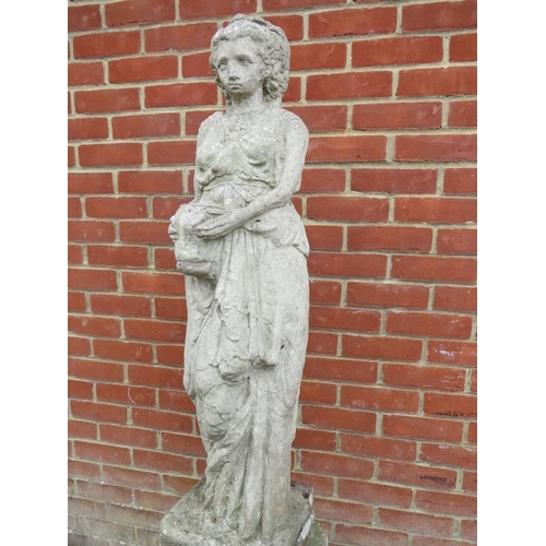 896 - A large weathered reconstituted stone statue in the form of a Grecian goddess, on an Ionic column pe... 