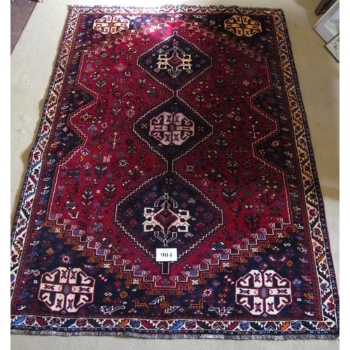 904 - A fine South West Persian Qashqai rug.  Three centred triangle motifs on red ground.  240cm x 165cm ... 