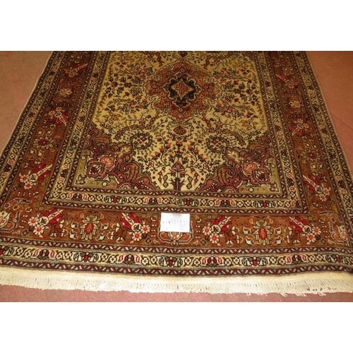 906 - North West Persian Tabriz rug, central motif surrounded by foliage on cream/brown field. 182cm x 148... 