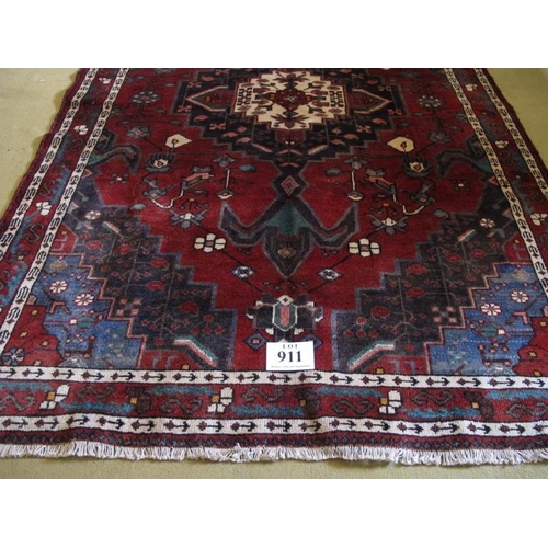 911 - South West Persian Afshar rug with a large central motif on red ground highlighted with blue, cream,... 