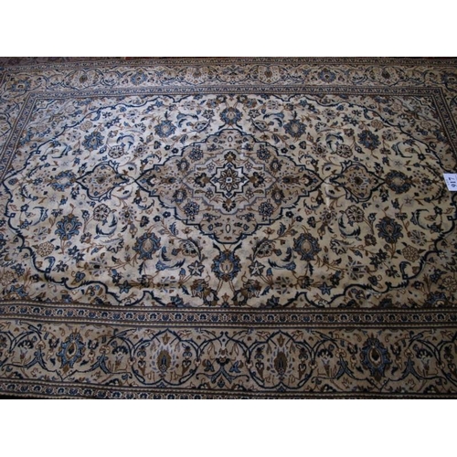 917 - A Persian Kashan carpet, central motif on a floral patterned design, blue on cream. 300cm x 198cm (a... 