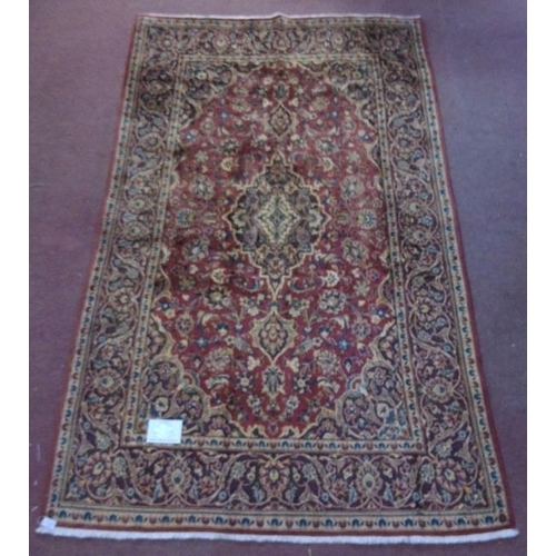 926 - A fine Kashan (Persian) rug on a claret ground, the central motif & borders on a brown ground. 218cm... 