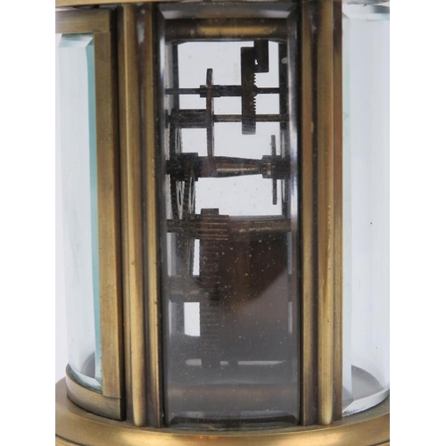 10 - A cylindrical brass carriage clock, 20th century. With a bevelled glass sides and enamelled Roman nu... 