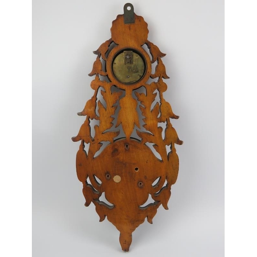 11 - A Victorian foliate carved aneroid barometer with clock. Incorporated with an inscribed presentation... 