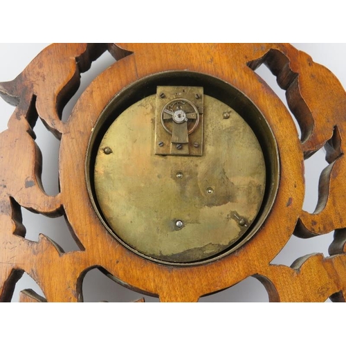 11 - A Victorian foliate carved aneroid barometer with clock. Incorporated with an inscribed presentation... 