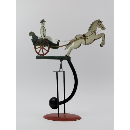 116 - A vintage Folk Art pony and trap painted metal pendulum balance toy. 42.2 cm height. Condition repor... 