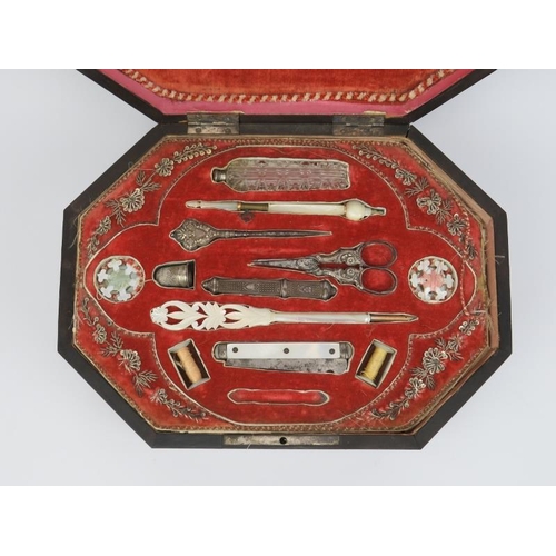 16 - A French musical sewing box, 19th century. Of elongated octagonal form, the hinged cover opening to ... 