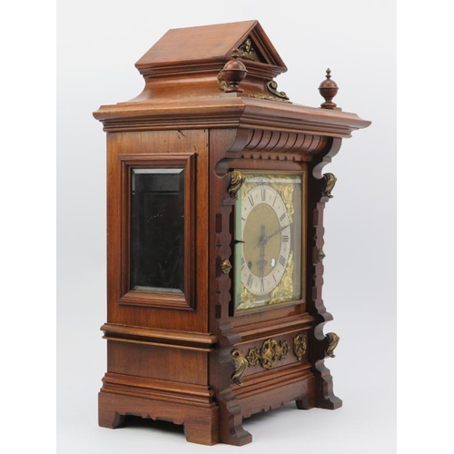 18 - A German mahogany mantel clock, late 19th century. The architectural case with bevelled glass window... 