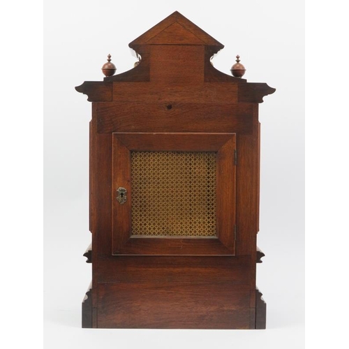 18 - A German mahogany mantel clock, late 19th century. The architectural case with bevelled glass window... 