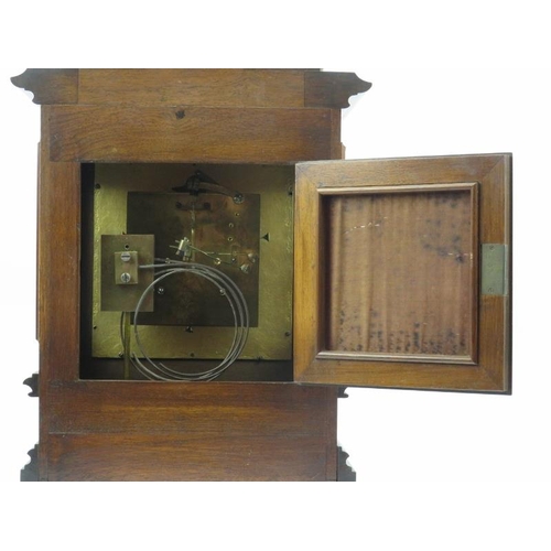 18 - A German mahogany mantel clock, late 19th century. The architectural case with bevelled glass window... 