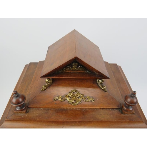 18 - A German mahogany mantel clock, late 19th century. The architectural case with bevelled glass window... 