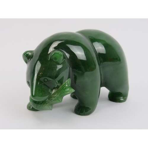 272 - A Canadian carved jade bear with salmon in mouth, 20th century. 8.8 cm length. 
Condition report: Li... 