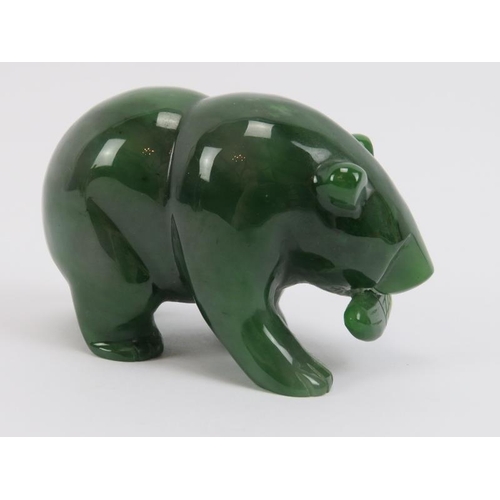 272 - A Canadian carved jade bear with salmon in mouth, 20th century. 8.8 cm length. 
Condition report: Li... 