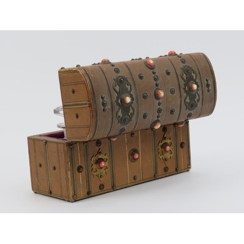 3 - A Victorian travelling scent bottle casket. Of chest form with studded brass work and cabochons, the... 