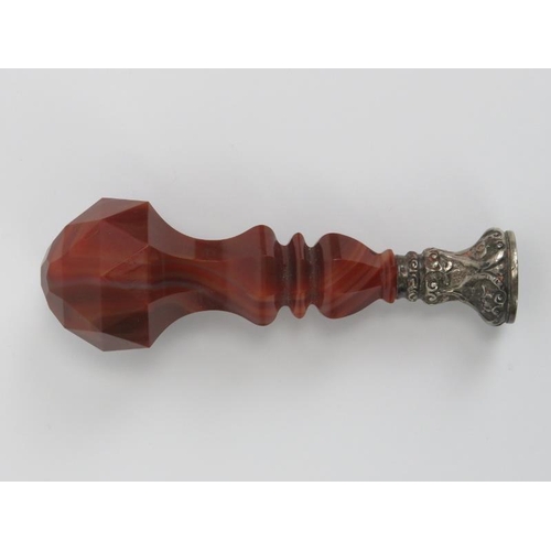 4 - A large faceted agate stone and silver desk seal, 19th century. The agate handle mounted on a scroll... 