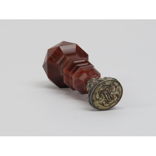 4 - A large faceted agate stone and silver desk seal, 19th century. The agate handle mounted on a scroll... 