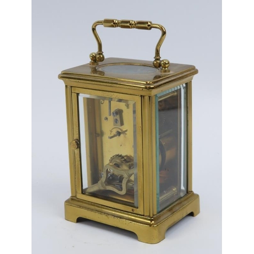 52 - A French brass carriage clock, 20th century.  With white enamelled dial and Roman numerals. Key incl... 