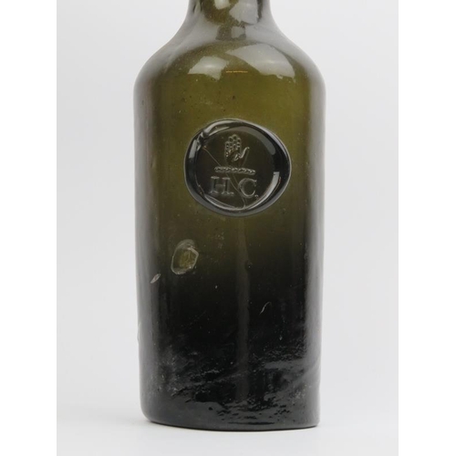 8 - A Georgian English cylindrical green glass bottle with seal, late 18th/early 19th century. Seal bear... 