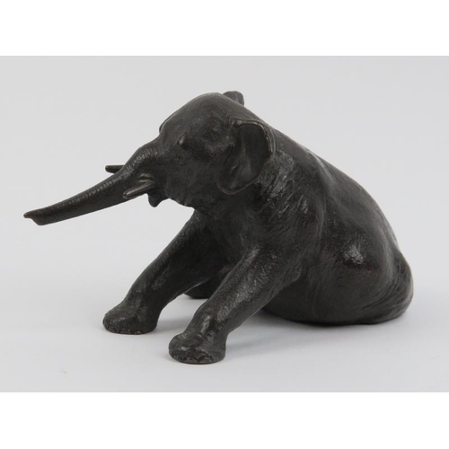 91 - A bronze sculptural study of a recumbent elephant, 20th century. 14 cm length. Foundry mark beneath.... 