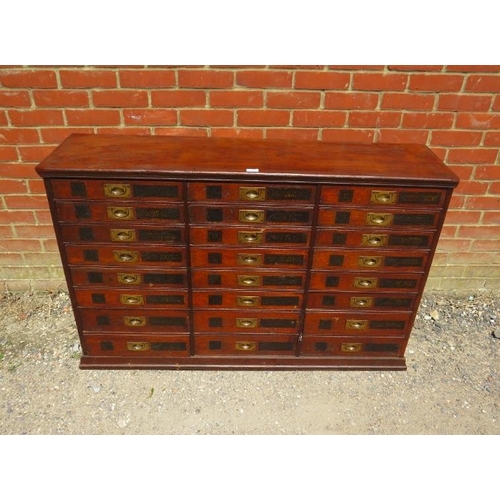 701 - A 19th Century mahogany haberdashery bank of 24 drawers, having brass campaign style handles and han... 