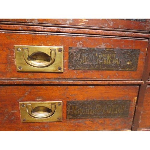 701 - A 19th Century mahogany haberdashery bank of 24 drawers, having brass campaign style handles and han... 