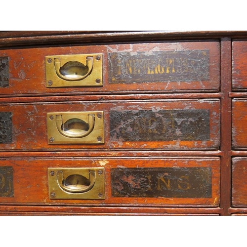 701 - A 19th Century mahogany haberdashery bank of 24 drawers, having brass campaign style handles and han... 