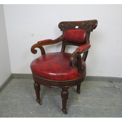 702 - A William IV mahogany revolving desk chair, the carved back joined with scrolled arms to a to a revo... 