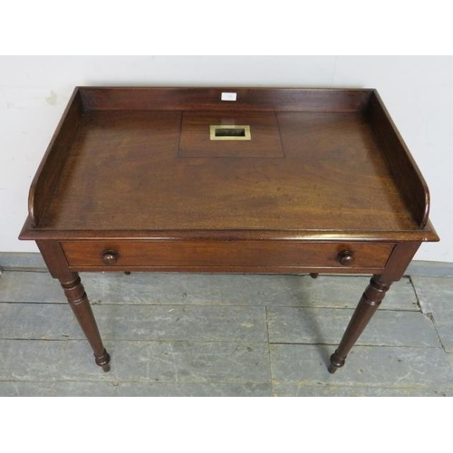 708 - A rare Georgian mahogany rent table, the ¾ gallery enclosing a brass bound slot, housing one long co... 