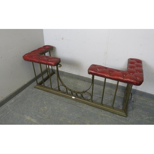 719 - An Edwardian brass club fender, the corner seats upholstered in antique buttoned claret leather with... 