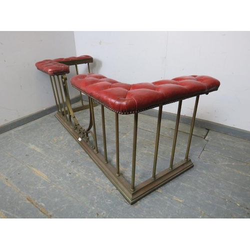 719 - An Edwardian brass club fender, the corner seats upholstered in antique buttoned claret leather with... 