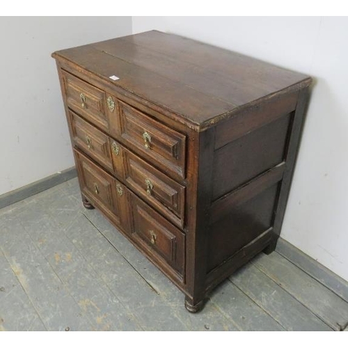 727 - A 17th century oak chest, housing three graduated long drawers with split geometric mouldings and fa... 