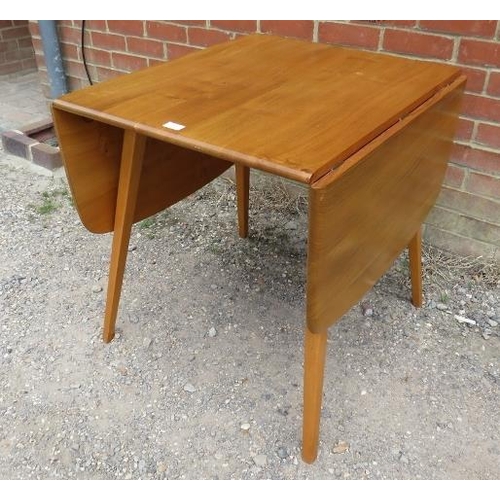 753 - A mid-century elm and beech drop-leaf Windsor dining table by Ercol, on canted supports. c1960.
H71c... 