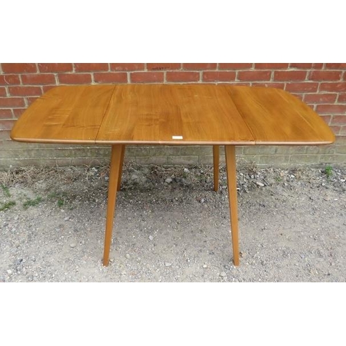 753 - A mid-century elm and beech drop-leaf Windsor dining table by Ercol, on canted supports. c1960.
H71c... 