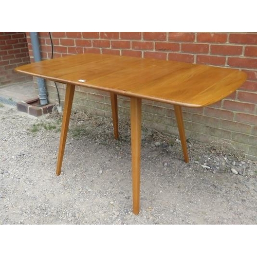 753 - A mid-century elm and beech drop-leaf Windsor dining table by Ercol, on canted supports. c1960.
H71c... 