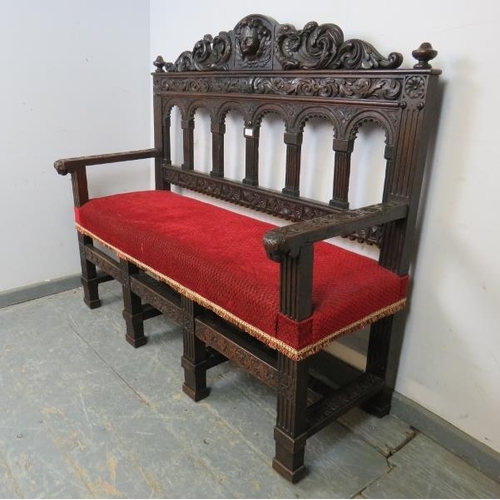 756 - A 19th century Gothic revival oak hall bench, having turned finials and profuse acanthus leaf decora... 