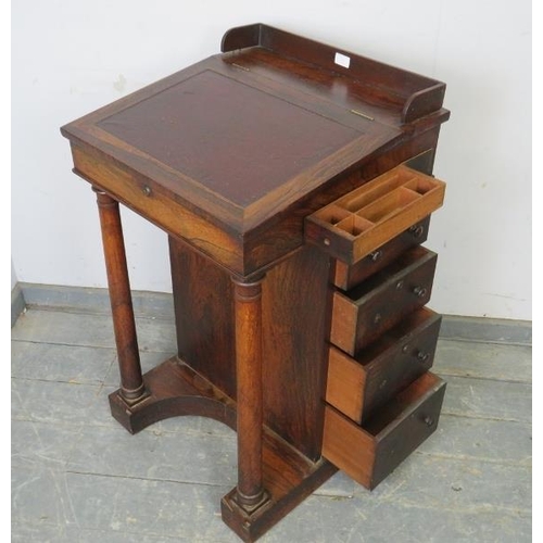 761 - A 19th century rosewood Davenport, the ¾ gallery above a leather-bound writing slope opening onto a ... 