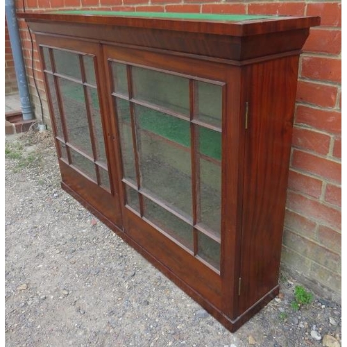 782 - A 19th century mahogany gun cabinet, the glazed door s opening onto loose shelves, above 10 short oa... 