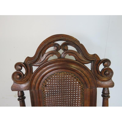 785 - A 17th century and later Carolean oak hall chair, the scroll carved and pierced cornice above a berg... 