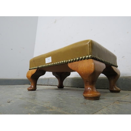 790 - A small antique walnut footstool, upholstered in green leather with brass studs, on ogee supports. 
... 