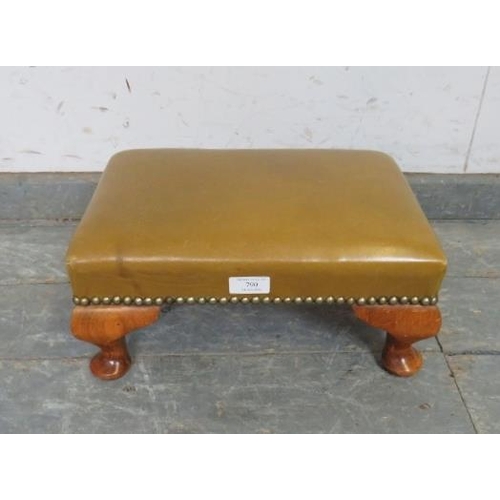 790 - A small antique walnut footstool, upholstered in green leather with brass studs, on ogee supports. 
... 