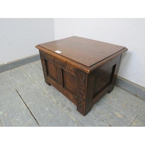 803 - A diminutive oak coffer, having carved front decoration and fielded panels, on bracket feet.
H33cm W... 