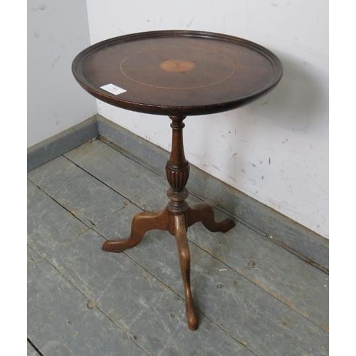 806 - A Georgian Revival mahogany wine table, the dished top with batwing central roundel, on a turned ped... 