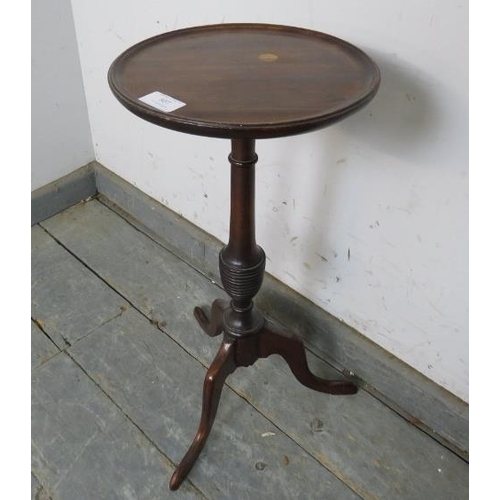 807 - A small Georgian Revival mahogany wine table, the dished top on a turned column with tripod supports... 